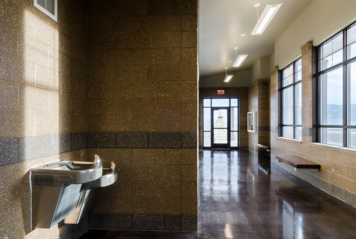 View inside of the Divide rest area with water fountains facing out toward benches and windows